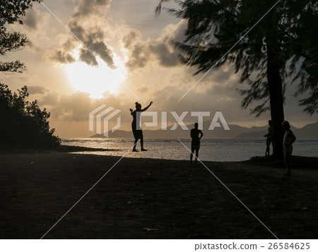 Teenagers walking on a tightrope at sunset  26584625