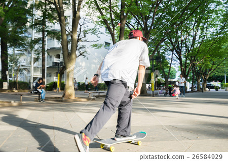 Men enjoying skateboarding 26584929