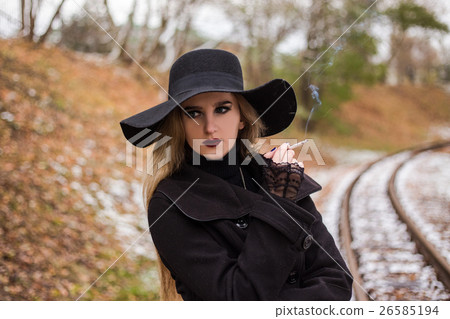 Young woman smoking a cigarette Young woman smoking a cigarette 26585194
