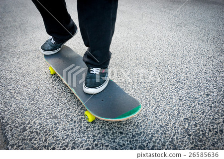 Men's feet on a skateboard 26585636