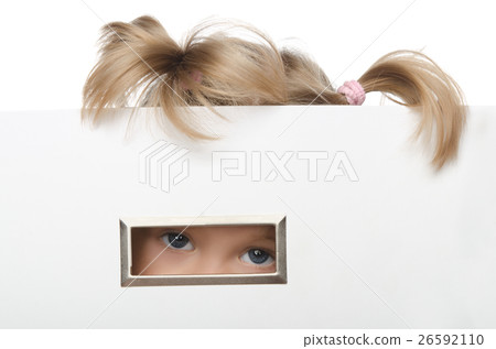 little girl looks inquisitively out of box 26592110