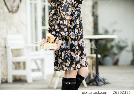 A young lady with a present 26592355