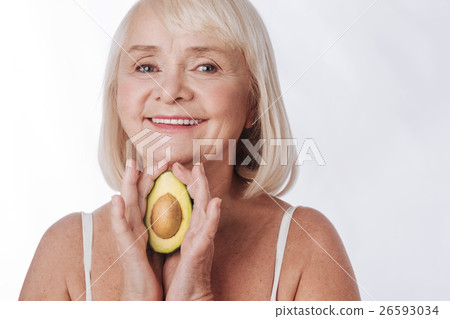Cheerful smiling woman holding a fruit in her 26593034