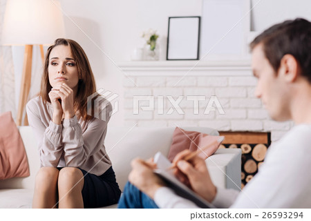 Pleasant young woman discussing her problems with 26593294