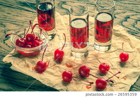 Glasses of cherry brandy with cocktail cherries Glasses of cherry brandy with cocktail cherries 26595359