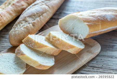 Three baguettes on the wooden background Three baguettes on the wooden background 26595822