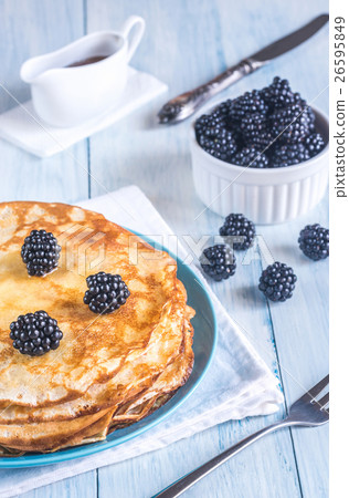 Crepes with blackberries on the wooden table 26595849