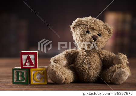 Teddy bear on on vintage wooden background 26597673