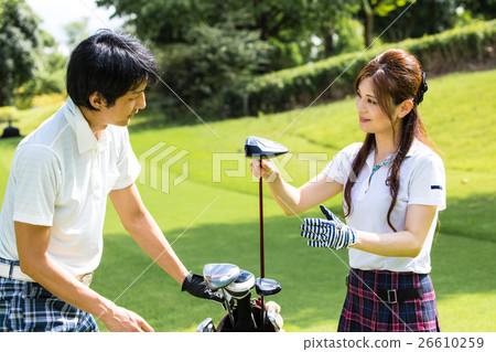 A golfer choosing a golf club 26610259