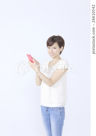 A young woman operating a smartphone A young woman operating a smartphone 26610542