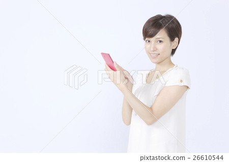 A young woman operating a smartphone A young woman operating a smartphone 26610544