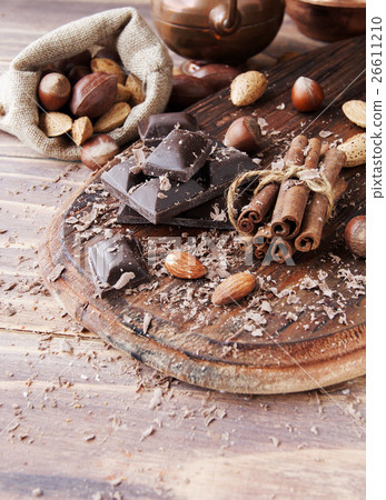 pieces of chocolate with nuts and cinnamon pieces of chocolate with nuts and cinnamon 26611210