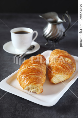 Two fresh croissants and cup of coffee Two fresh croissants and cup of coffee 26623859