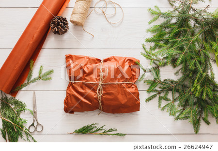Wrapping christmas present gift on white wood Wrapping christmas present gift on white wood 26624947