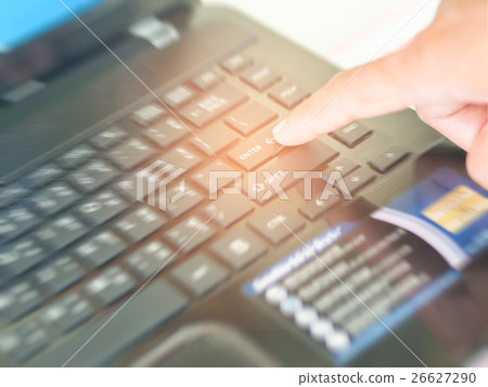 forefinger pressing ENTER button . 26627290
