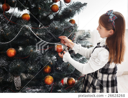 Pretty little girl decorate big christmas tree 26628268