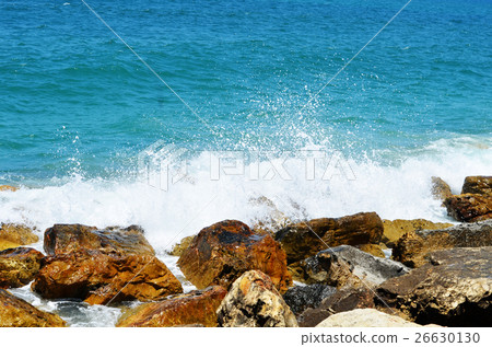 Sea waves break about stones 26630130