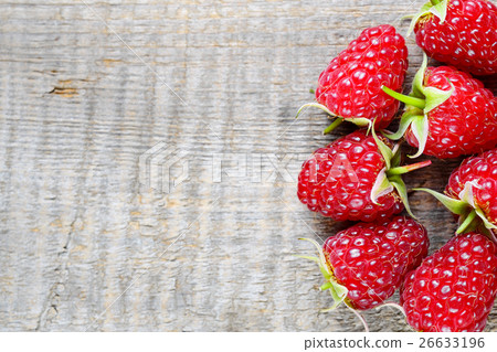 Raspberry close-up on wooden background 26633196