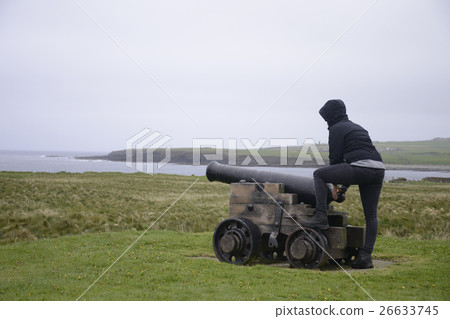 Girl shooting cannon Orkney coastline cliff 26633745