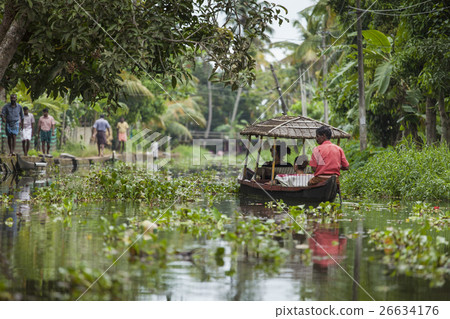Unidentified indian people in small boat in backwa 26634176