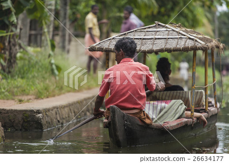 Unidentified indian people in small boat in backwa 26634177