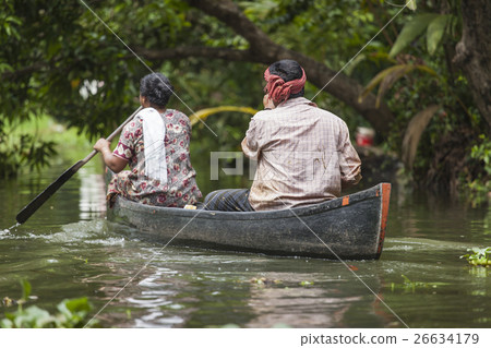 Unidentified indian people in small boat in backwa Unidentified indian people in small boat in backwa 26634179
