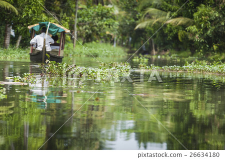 Unidentified indian people in small boat in backwa 26634180