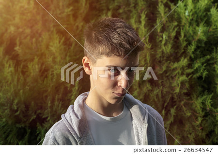 portrait of a devilish looking teenage boy 26634547