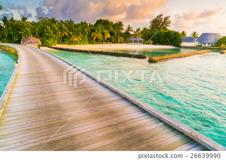 Beautiful water villas in tropical Maldives island at the sunrise time . Beautiful water villas in tropical Maldives island at the sunrise time . 26639990