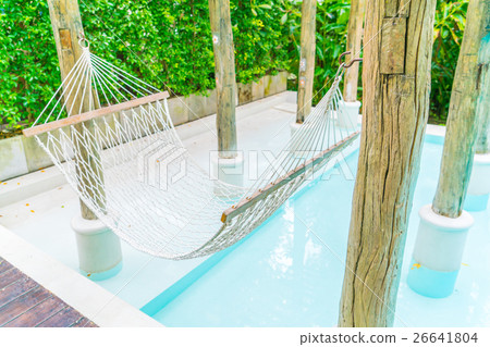 White hammocks in Luxury swimming pool . 26641804