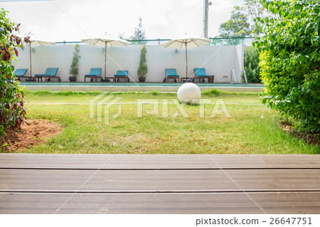 Wood plank on backyard swimming pool and sunbed Wood plank on backyard swimming pool and sunbed 26647751