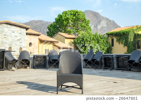 One black chair and table chair leaning 26647801