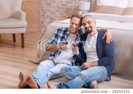 Smiling homosexual couple drinking wine in the Smiling homosexual couple drinking wine in the 26650142