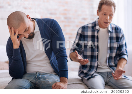 Irritated homosexual couple quarrelling with each Irritated homosexual couple quarrelling with each 26650260