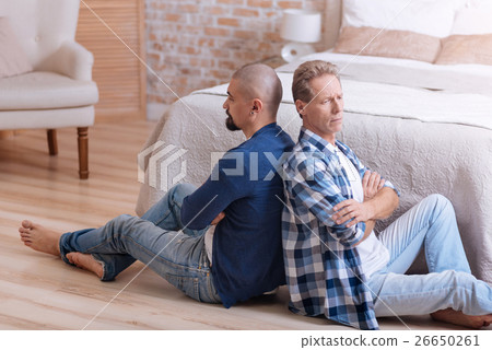 Upset gay couple sitting with crossed arms Upset gay couple sitting with crossed arms 26650261