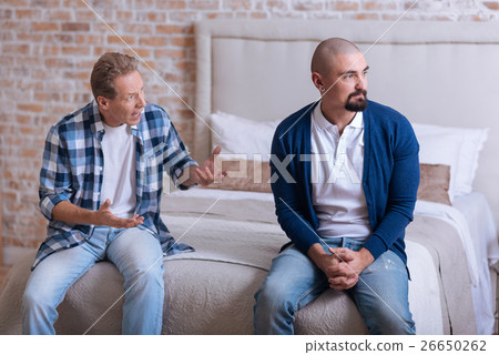 Furious man shouting on his son at home Furious man shouting on his son at home 26650262