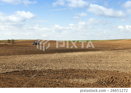 tractor plowing the fields 26651272