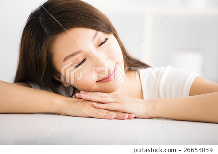 relaxed young smiling woman  in living room 26653039