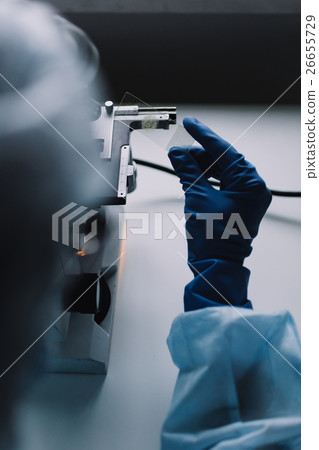 Crop hands putting microscope glasses in box 26655729