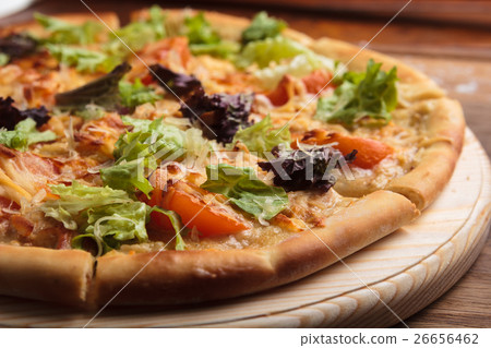 Caesar pizza on messy wooden background. Caesar pizza on messy wooden background. 26656462