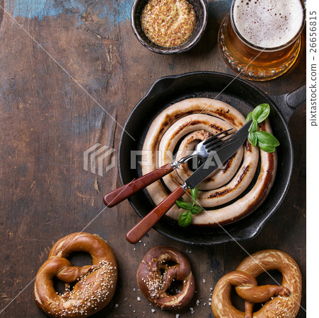 Lager beer with sausage and pretzels 26656815