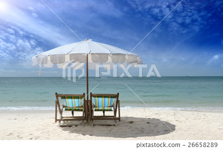 Relax chair on the beach under white umbrella Relax chair on the beach under white umbrella 26658289