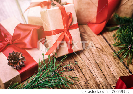 Christmas presents with red ribbon on dark wooden Christmas presents with red ribbon on dark wooden 26659962