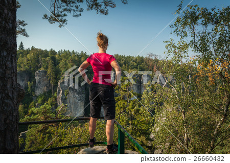 Young woman and her dog enjoy mountain hikes  26660482