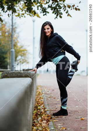 Woman runner stretching legs before run. 26661540