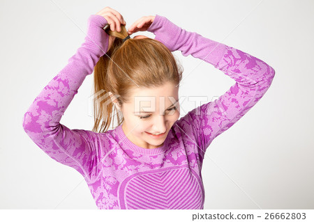 girl collecting hair in a ponytail on the gum girl collecting hair in a ponytail on the gum 26662803