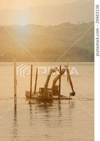 Two shovel buckets on pontoon are dig mud Two shovel buckets on pontoon are dig mud 26663136