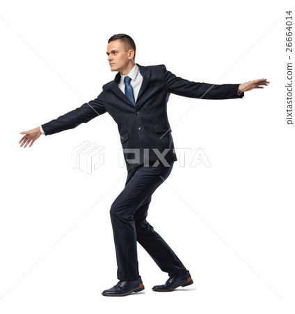 Fully concentrated businessman walking tightrope Fully concentrated businessman walking tightrope 26664014