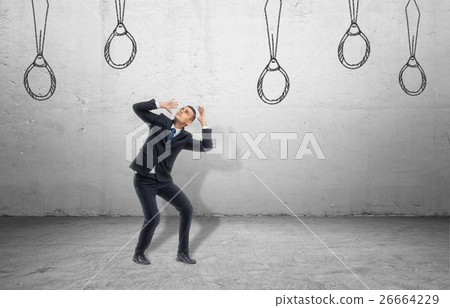 Businessman surrounded by ties drawn on wall 26664229