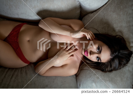 Top view of topless busty brunette lying on sofa 26664524